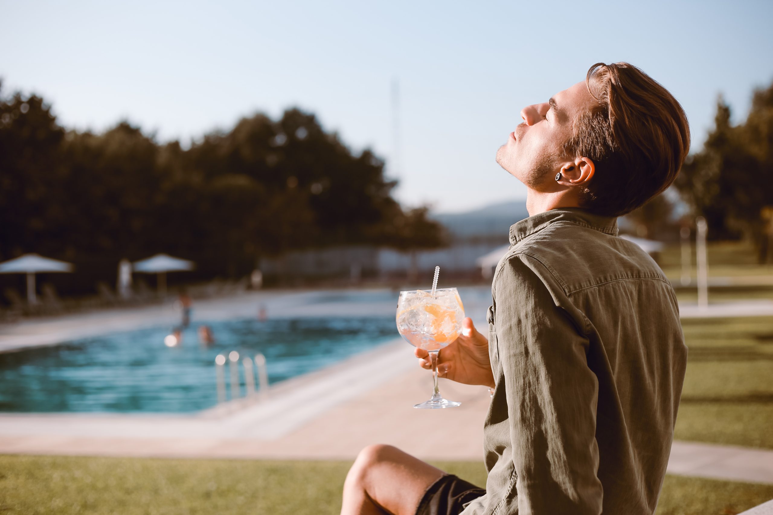 Man drinking cocktail near the pool - Spring and Summer